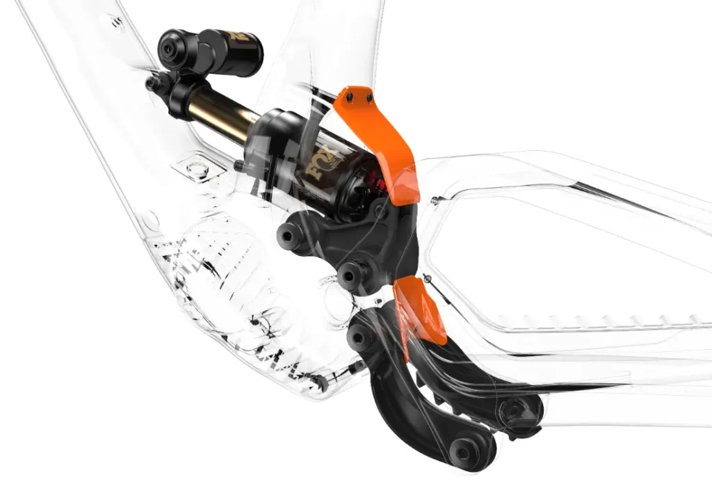 Primer plano de un cuadro de bicicleta UNNO MITH transparente que muestra componentes de suspensión detallados con un detalle naranja y un amortiguador negro, resaltando el diseño de ingeniería y la funcionalidad.
