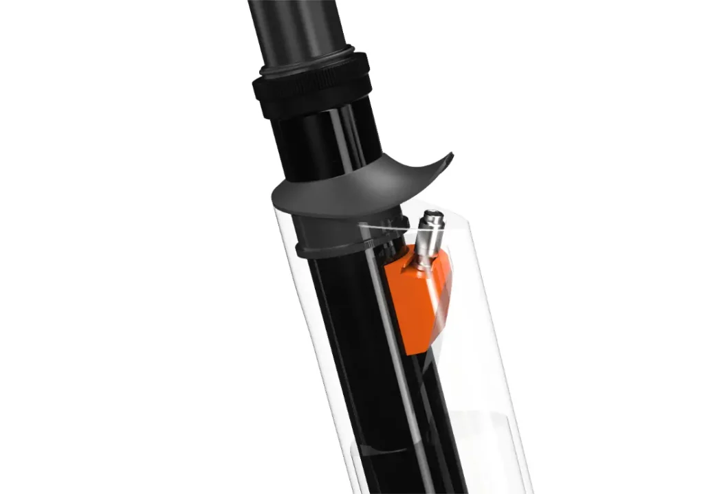 Primer plano de la tija del sillín de bicicleta UNNO MITH con una sección transparente, que revela un intrincado mecanismo interno de color naranja.