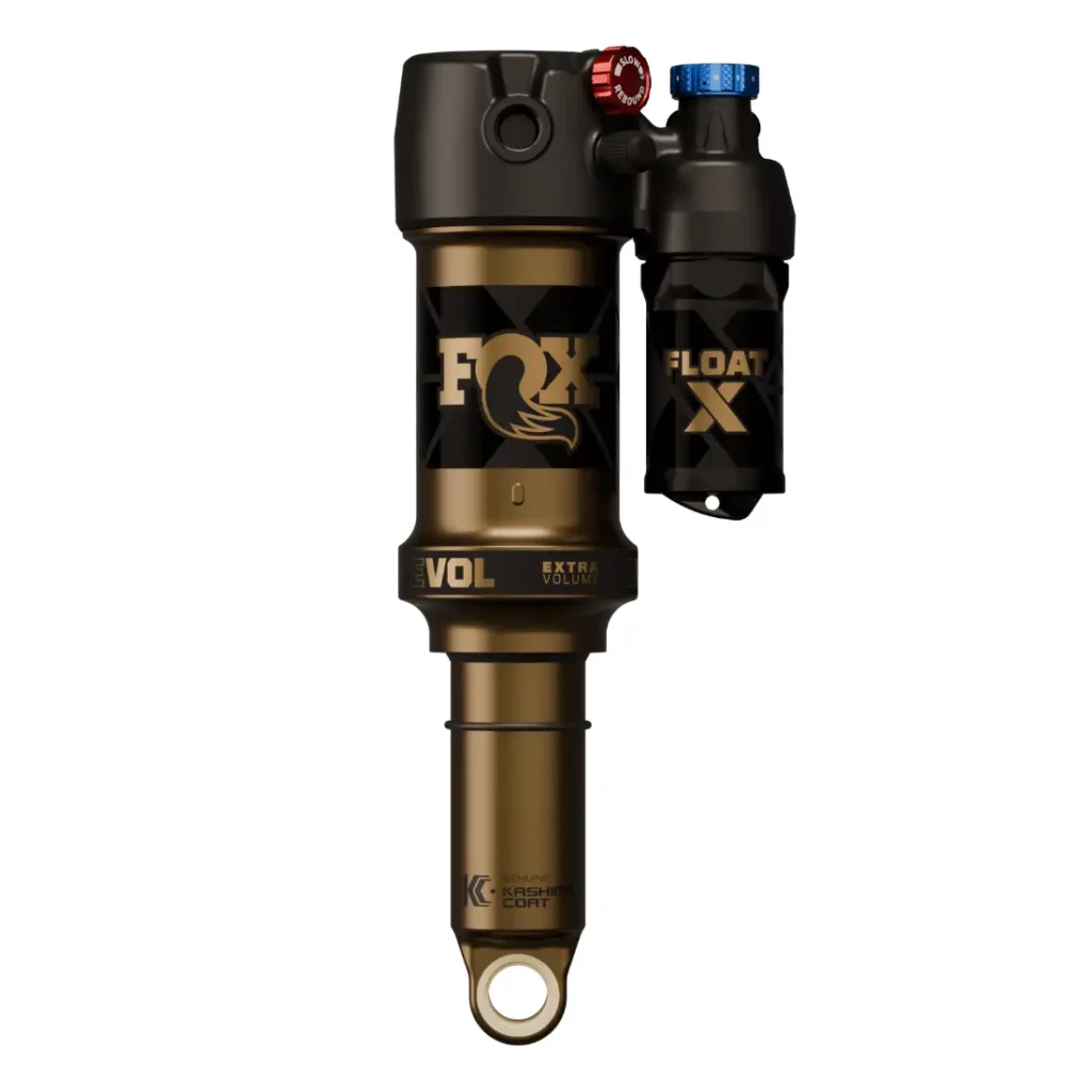 Un amortiguador trasero FOX Float X para bicicleta de montaña con un acabado en negro y dorado, con mandos de ajuste para el control de suspensión y amortiguadores distintivos de la marca FOX.