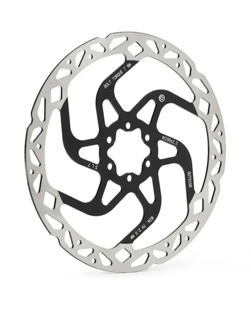 Un disco de freno de bicicleta Brembo GR-PRO con el centro negro y el borde exterior plateado, con dibujos recortados y marcas técnicas, ideal para frenos para e-MTB.