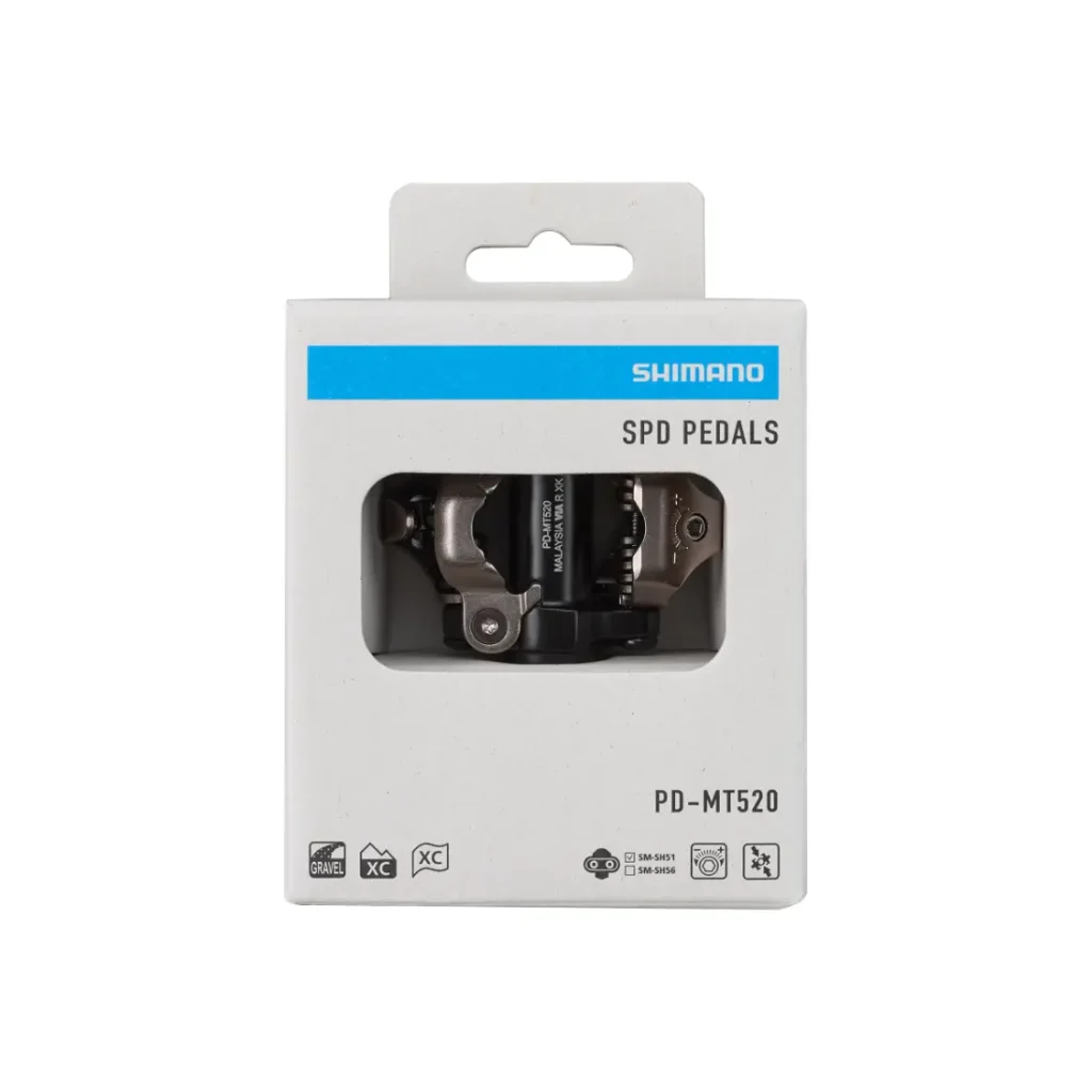Una caja de pedales Shimano DEORE XT SPD Trail, modelo PD-MT520, expuesta en su embalaje de venta al público, con los pedales visibles a través de una ventana transparente.