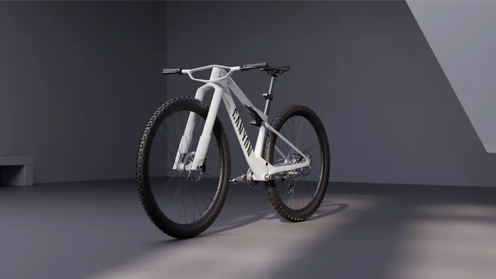 Una moderna bicicleta de montaña blanca, con ruedas anchas de 32 y un cuadro de geometría especial, descansa sobre un suelo gris liso en una estancia minimalista y bien iluminada, mostrando los últimos avances de la revolución de la industria ciclista.