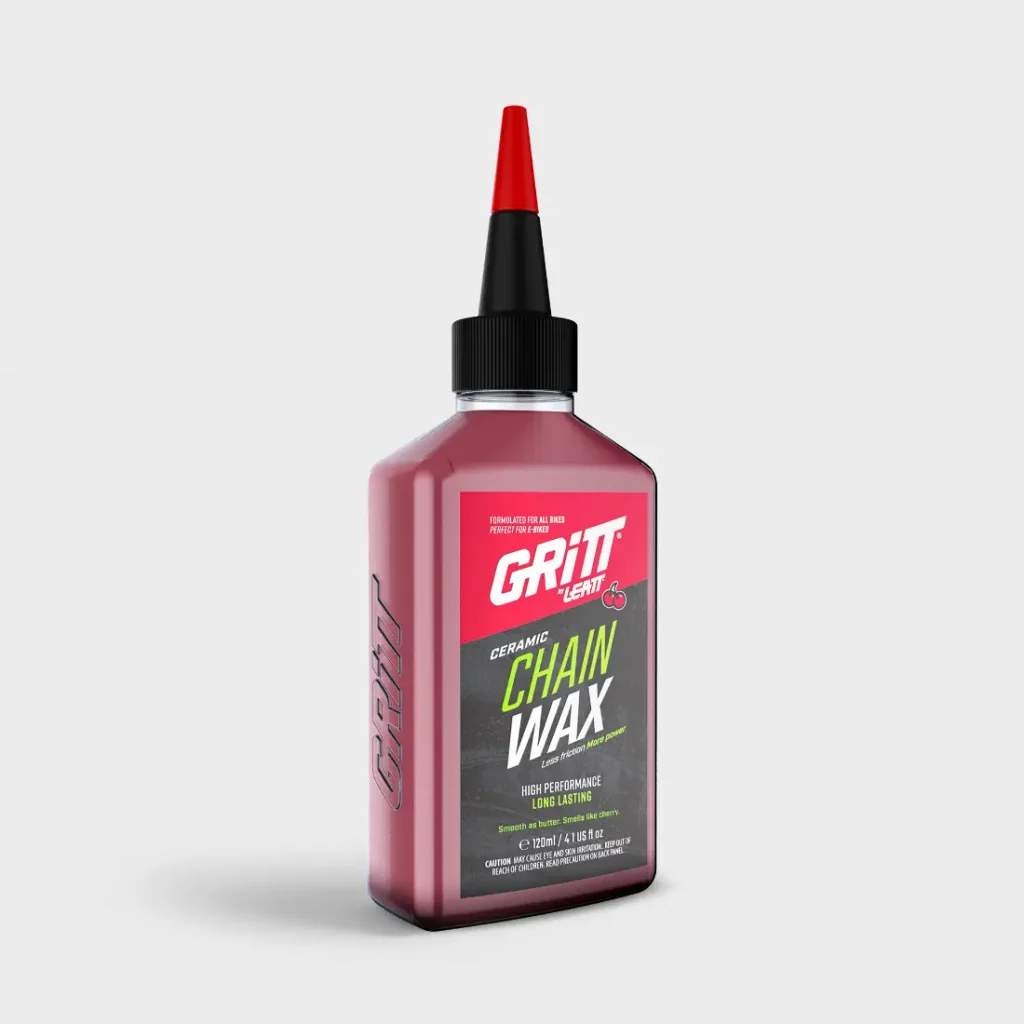 Un frasco de cera cerámica para cadenas Leatt Grit con boquilla roja.