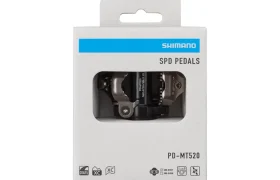 Una caja de pedales Shimano DEORE XT SPD Trail, modelo PD-MT520, expuesta en su embalaje de venta al público, con los pedales visibles a través de una ventana transparente.