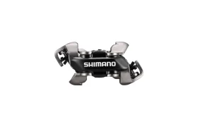 Tacón para pedales de bicicleta Shimano DEORE XT, de color metalizado con el centro negro, diseñado para su uso con pedales SPD XC Gravel y Trail, mostrado sobre un fondo blanco liso.